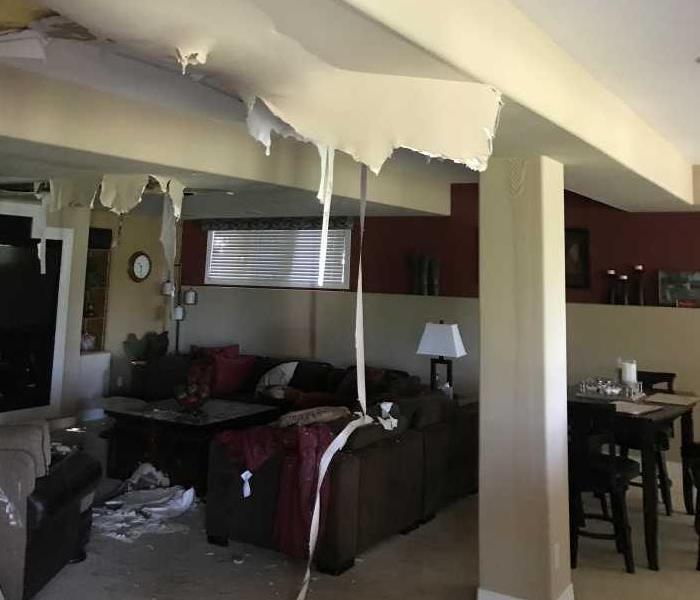 family room in Northglenn ceiling falling in due to to a toilet supply line bursting