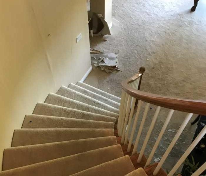 Water damage in home on staircase after a severe cold snap caused a frozen pipe to burst in Boulder          