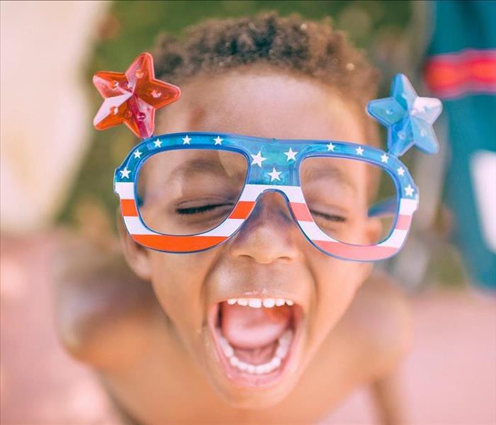 little boy with American flag glasses on