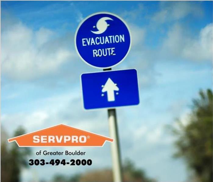 Evacuation route sign with SERVPRO of Greater Boulder logo