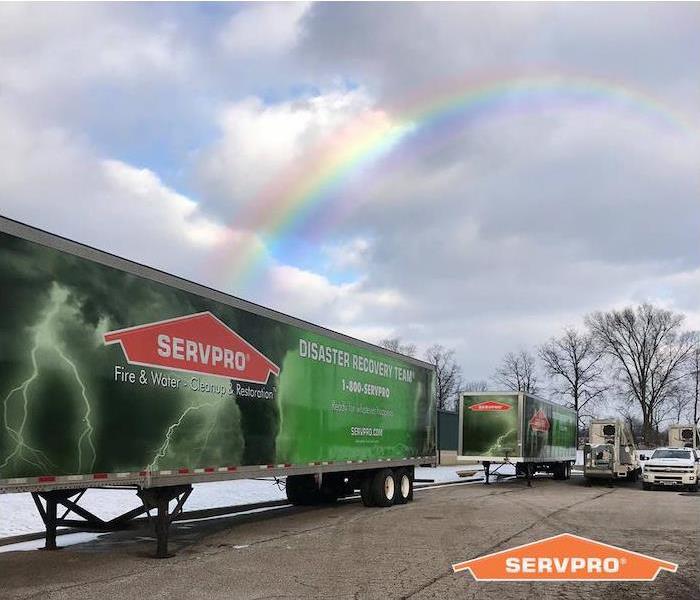 SERVPRO trailers outside with rainbow above it. 