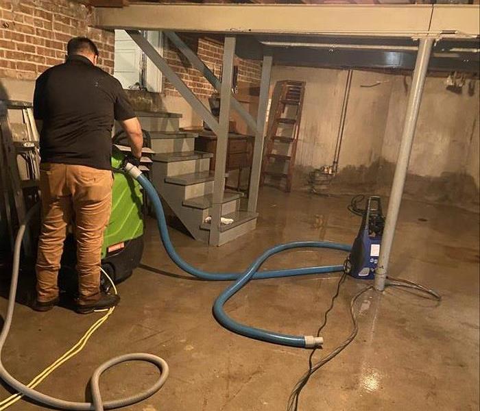 SERVPRO tech cleaning out flooded basement in Louisville
